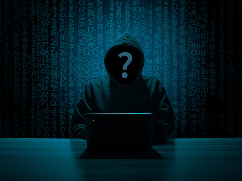 hacker sat a laptop