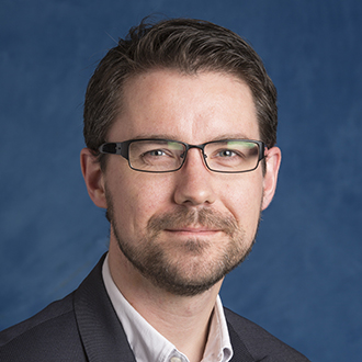 Man with beard and glasses smiling